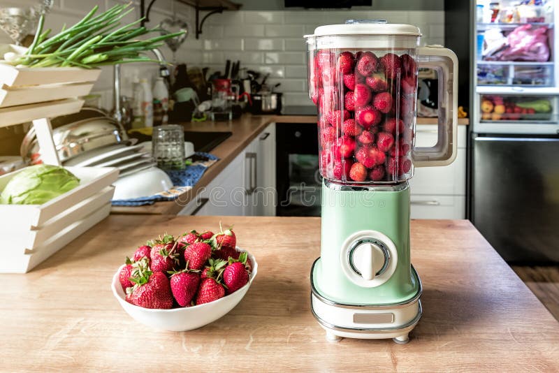 Sweet fresh strawberry cocktail in vintage retro blender on the kitchen table