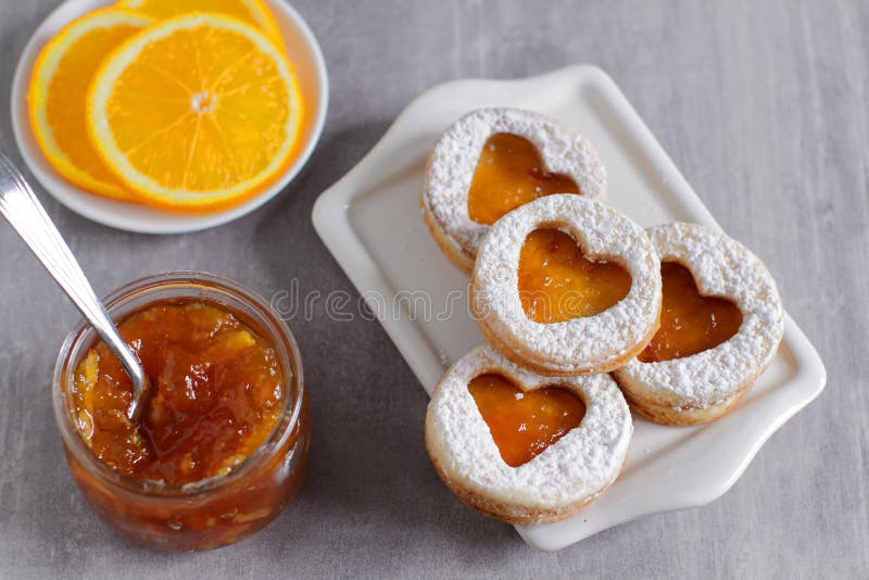 Sweet homemade love sandwich cookies with jam. Sweet homemade love sandwich cookies with orange jam, top view royalty free stock images Sweet homemade love sandwich cookies with jam. Sweet homemade love sandwich cookies with orange jam, top view royalty free stock images