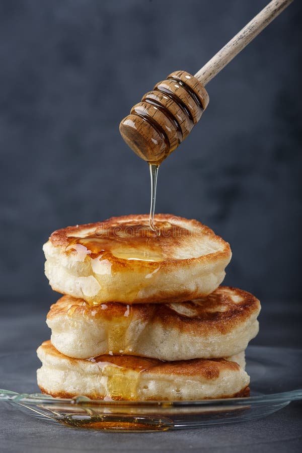 Sweet homemade pancakes in a glass plate with honey for breakfast stock photo Sweet homemade pancakes in a glass plate with honey for breakfast stock photo