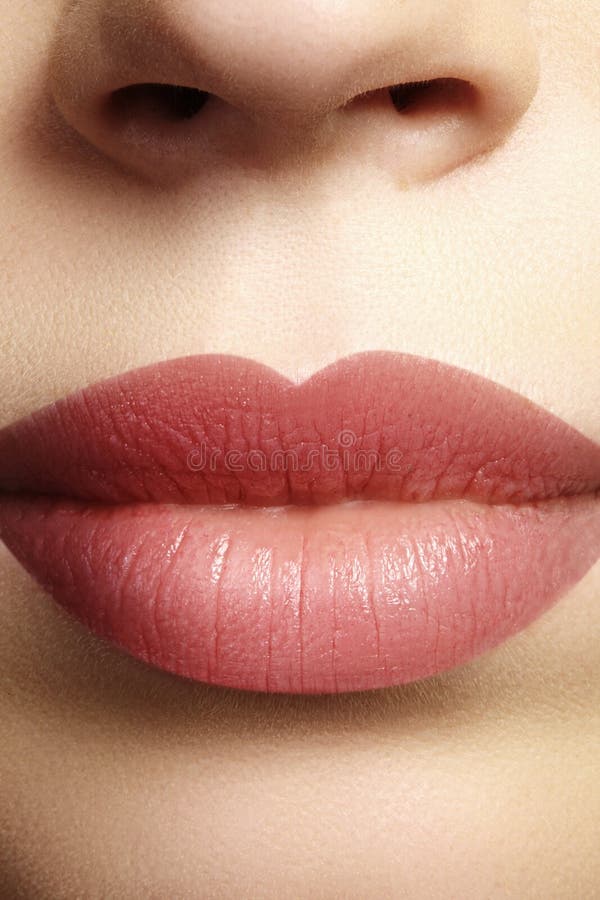 Sweet kiss. Perfect natural lip makeup. Close up macro photo with beautiful female mouth. Plump full lips