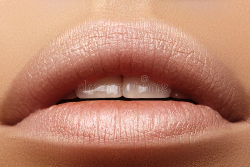 Sweet kiss. Perfect natural lip makeup. Close up macro photo with beautiful female mouth. Plump full lips