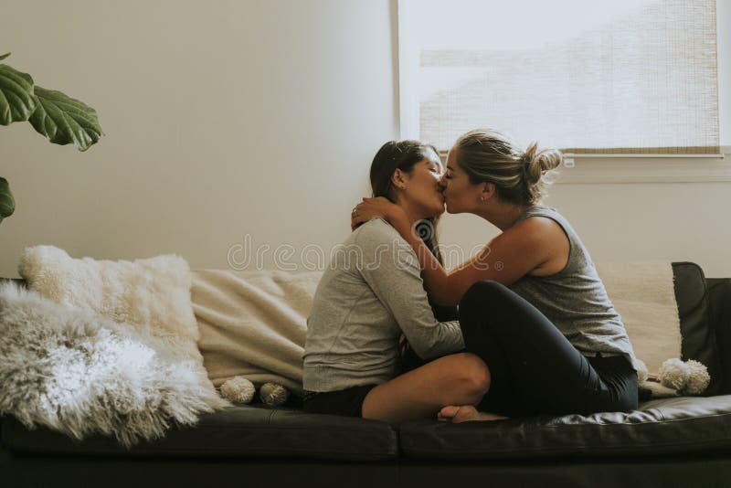 Lesbians Kissing On Couch