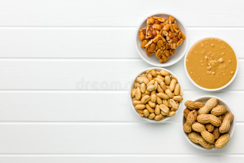Sweet Peanut Brittle, Peanuts and Peanuts Butter on White Table. Top View Stock Image Image of