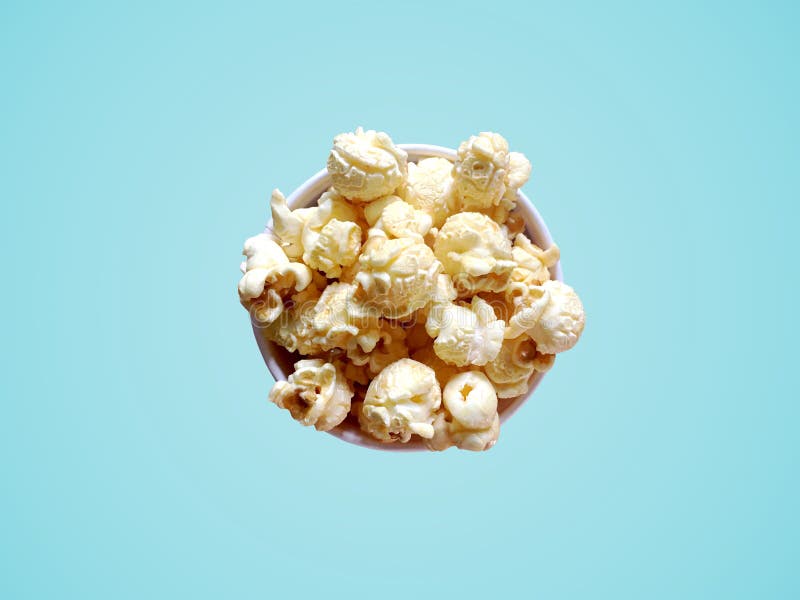 Sweet popcorn with caramel flavor in paper bowl on blue background. royalty free stock photos Sweet popcorn with caramel flavor in paper bowl on blue background. royalty free stock photos