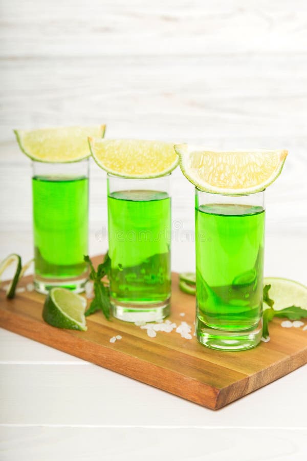 Sweet Refreshing Mint Liqueur, with Ice and Mint Leaves on Table
