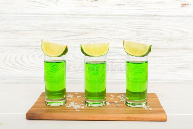 Sweet Refreshing Mint Liqueur, with Ice and Mint Leaves on Table