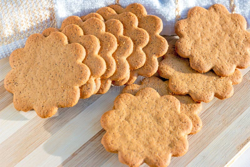 Sweet Swedish almond thins with ginger and cinnamon (Pepparkaka or Pepparkakor biscuits) on light wooden background. royalty free stock images Sweet Swedish almond thins with ginger and cinnamon (Pepparkaka or Pepparkakor biscuits) on light wooden background. royalty free stock images