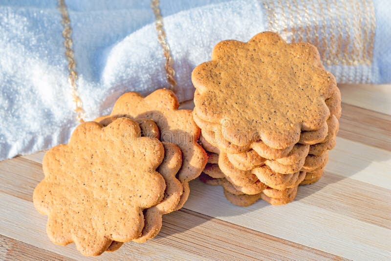 Sweet Swedish almond thins with ginger and cinnamon (Pepparkaka or Pepparkakor biscuits) on light wooden background. royalty free stock image Sweet Swedish almond thins with ginger and cinnamon (Pepparkaka or Pepparkakor biscuits) on light wooden background. royalty free stock image