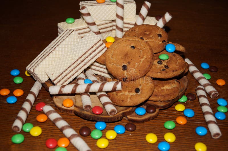 Sweet waffles, biscuits, candies. On a wooden table stock photos Sweet waffles, biscuits, candies. On a wooden table stock photos