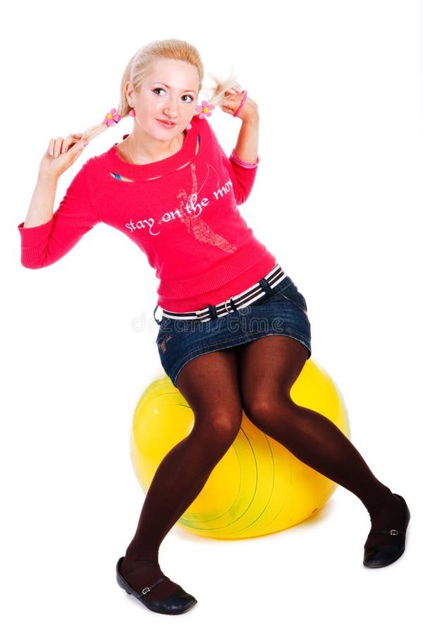 Sweet young girl sits on fitness ball