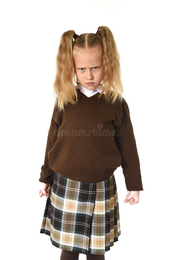 Sweet young schoolgirl in pigtails and school uniform looking angry upset frustrated and unhappy