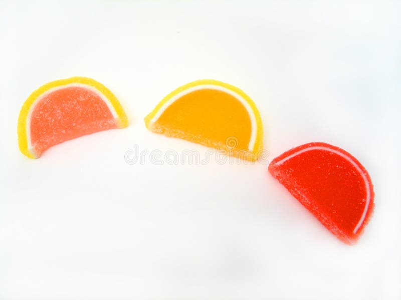 Three candy fruit slices on a white background. Three candy fruit slices on a white background.