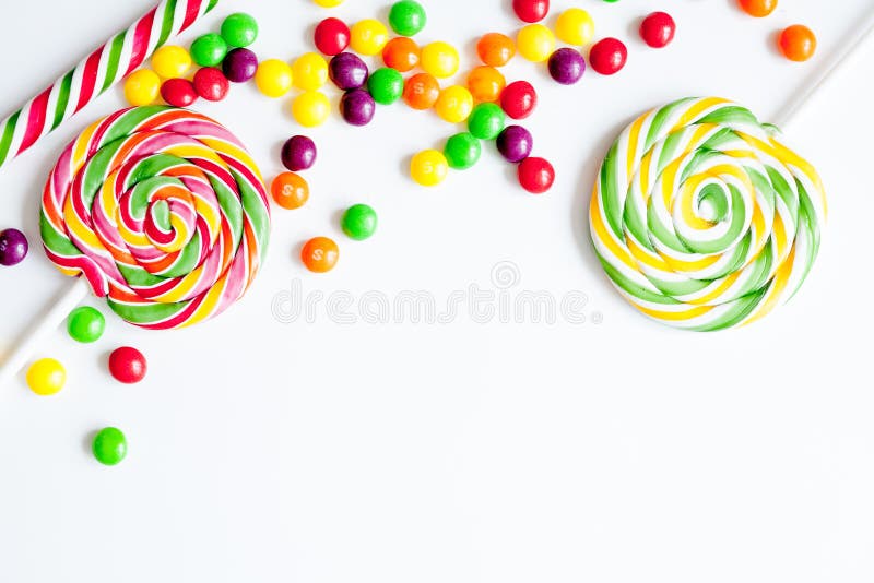 Sweets and sugar candies on white background top view