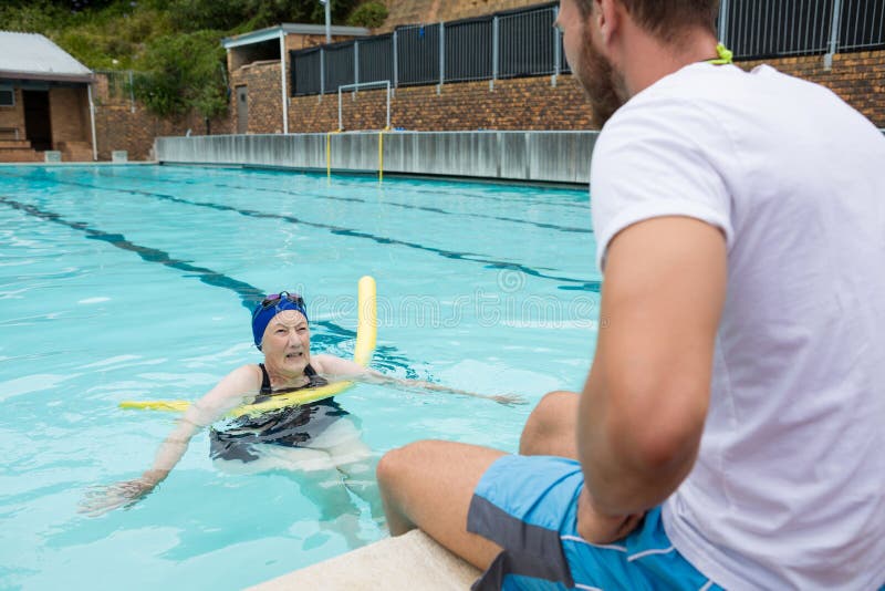 Swim Coach Interacting with Senior Woman Stock Image Image of leisure