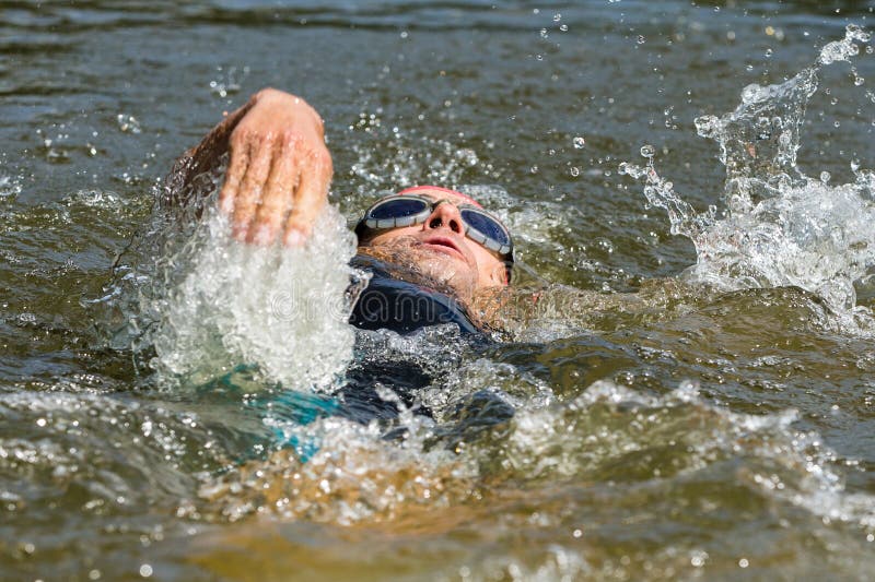 Swimmer in backstroke swimming stock images