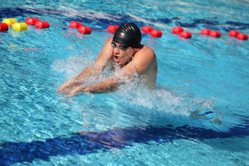 Swimmer in cap breathing performing the breaststroke royalty free stock photo Swimmer in cap breathing performing the breaststroke royalty free stock photo