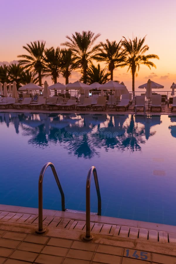 Swimming pool on Cyprus island at sunset