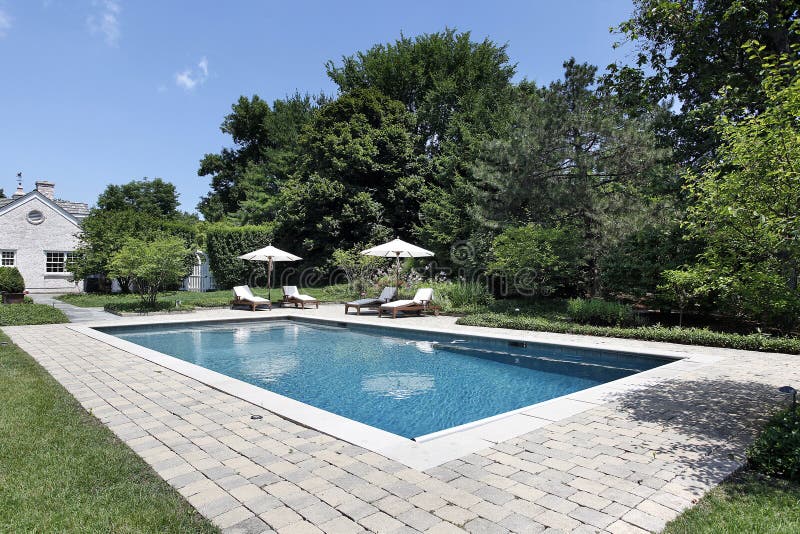 Swimming pool with deck chairs