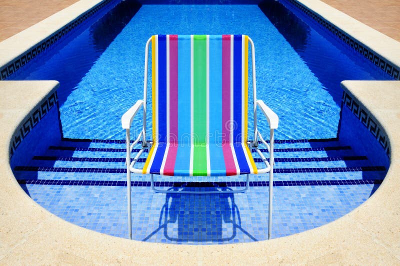 Swimming pool and deckchair royalty free stock photos