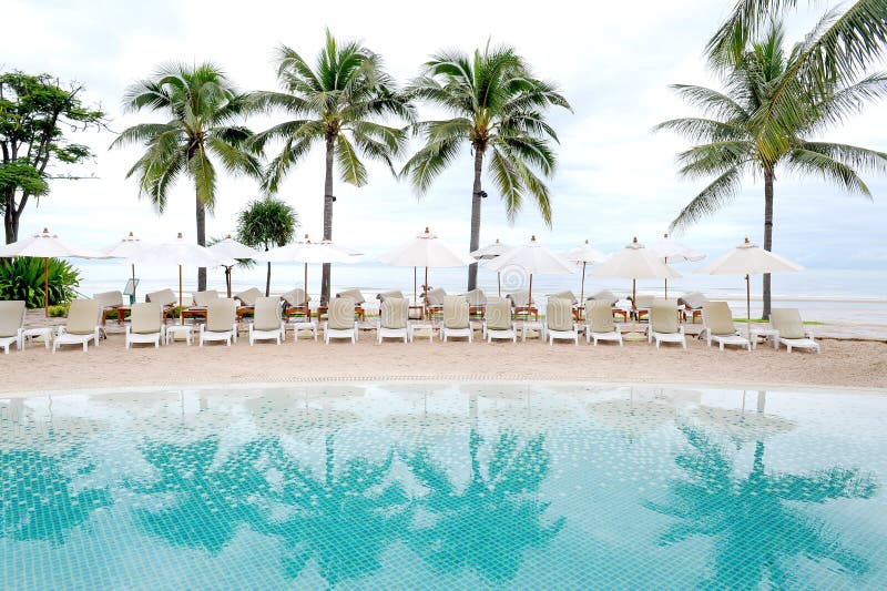 Swimming pool by sea at resort hotel