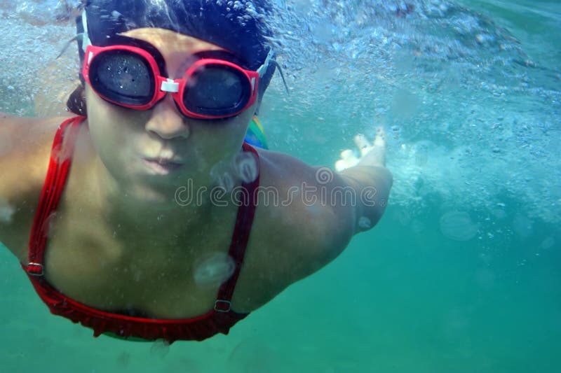 Little girl swimming underwater in sea. Little girl swimming underwater in sea