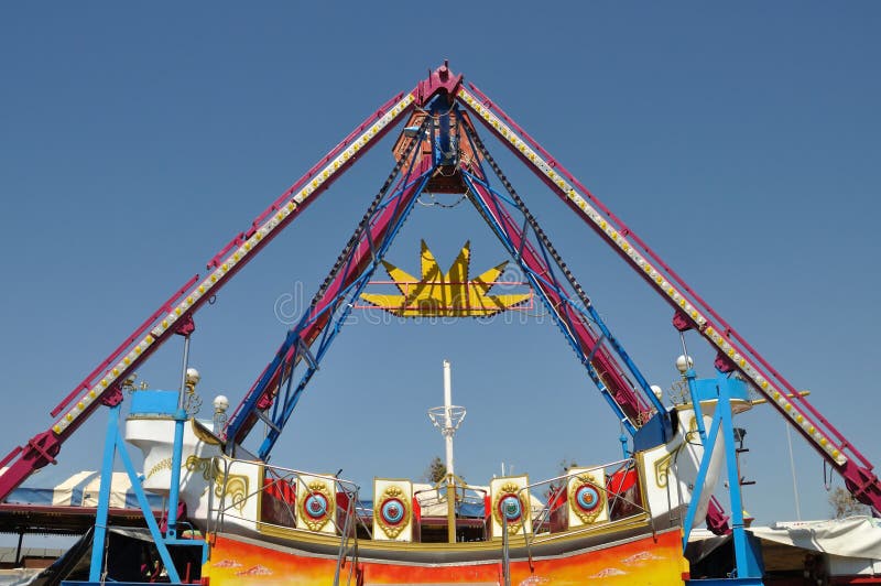 Colorful swing in amusement park. Abstract background.