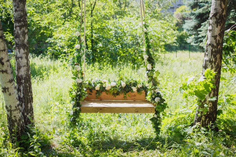 Swing overgrown with flowers
