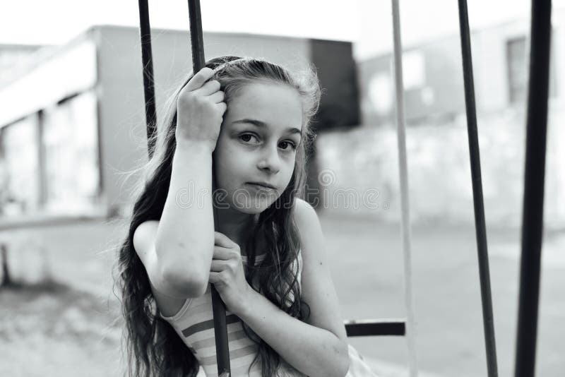 Swing ride - swinging girl. Girl riding a swing