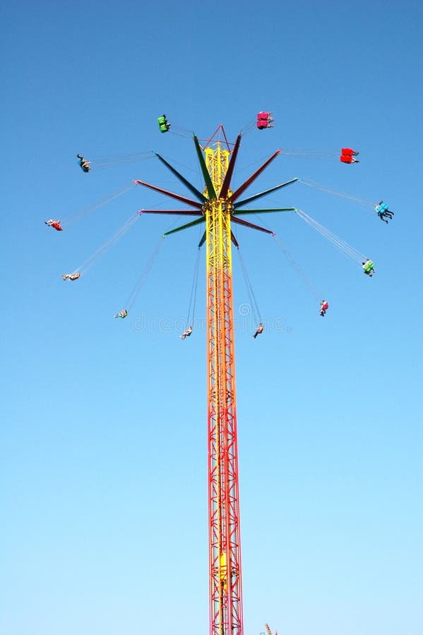 Swinging ride against blue sky at the amusement park. Swinging ride against blue sky at the amusement park