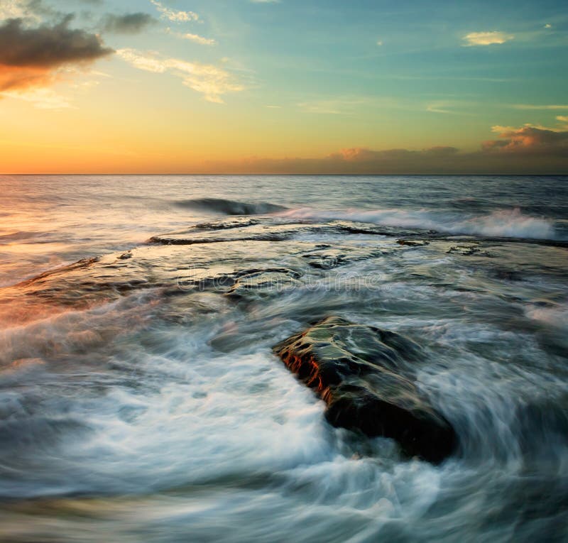 Swirling waves at sunset royalty free stock image