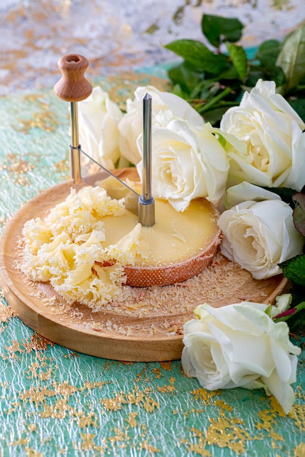 Swiss Cheese with Crumbs on a Wooden Surface and a Decorative Tablecloth  and Beautiful White Roses. Soft Focus. Stock Image - Image of cracks, blue:  190468939