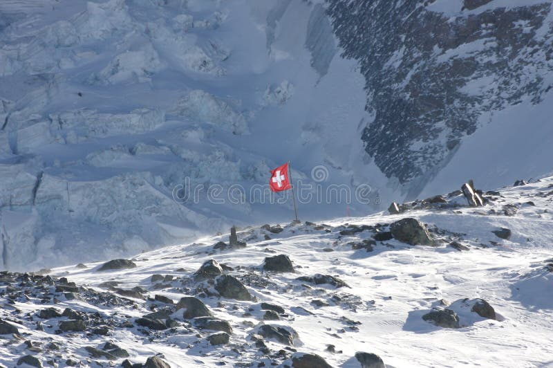 Swiss flag in rocky high alps