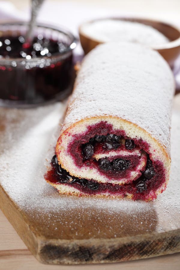 Swiss roll with black currant stock photos