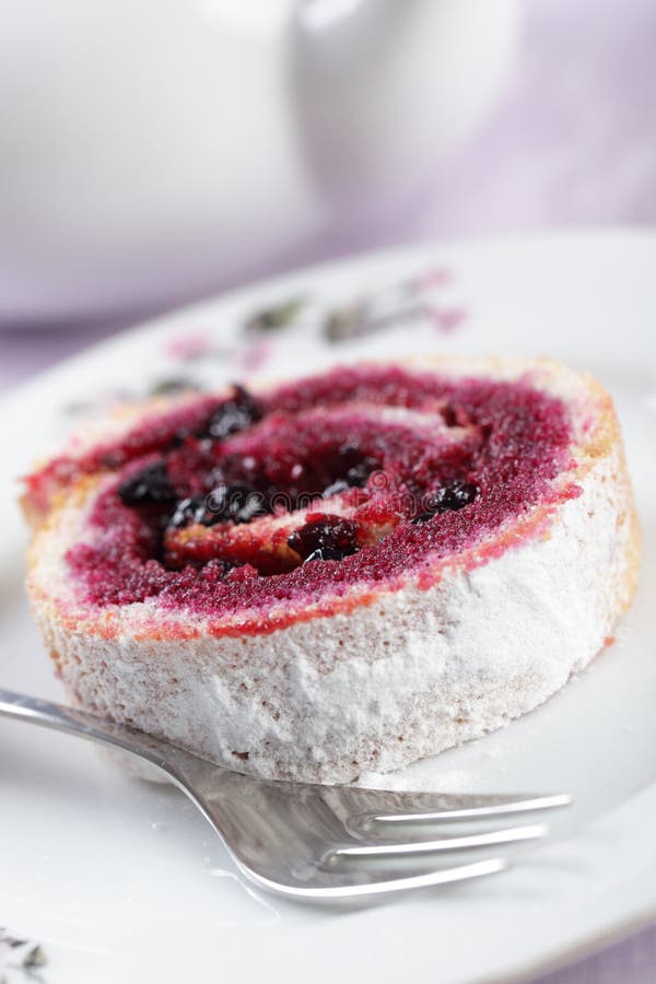Swiss roll with black currant stock photography