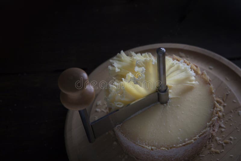 https://thumbs.dreamstime.com/b/swiss-semi-hard-cheese-made-unpasteurized-cow-s-milk-called-monk-head-stands-wooden-round-board-special-girolle-234412760.jpg
