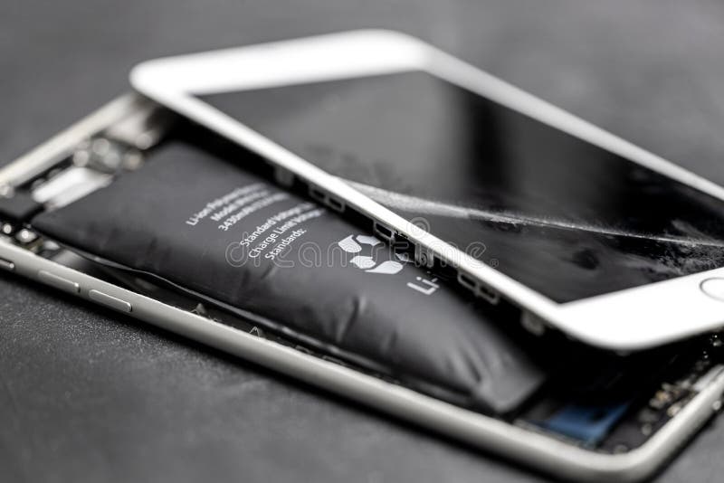 Swollen lithium-ion battery, modern smartphone, broken smartphone, battery-powered explosive electronics stock photography