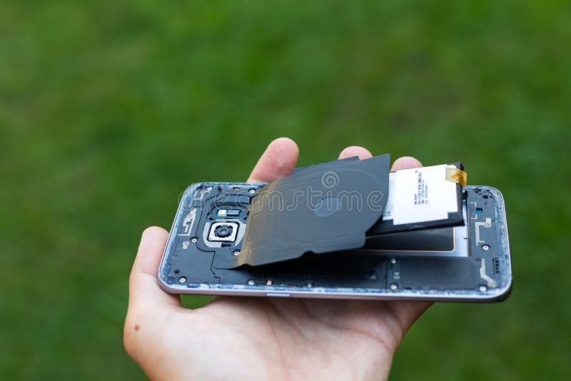 Swollen lithium smartphone battery. Close up of a damaged smartphone with expanded lithium ion battery