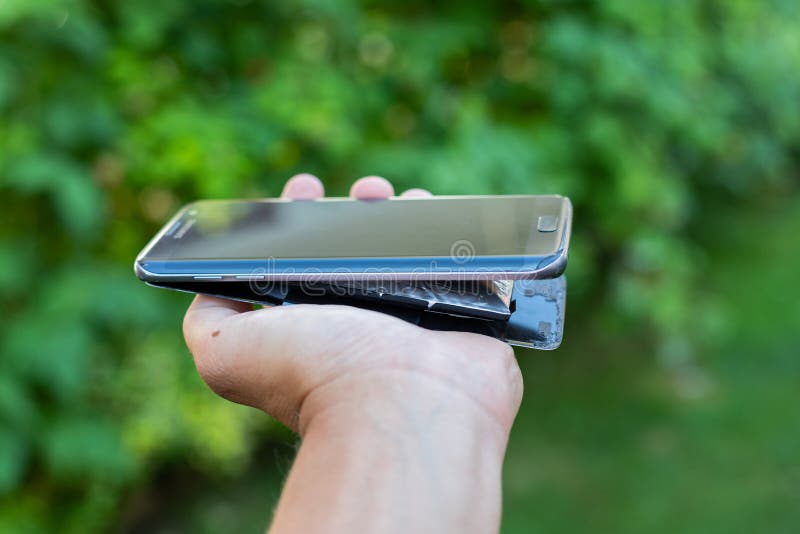 Swollen lithium smartphone battery stock photo