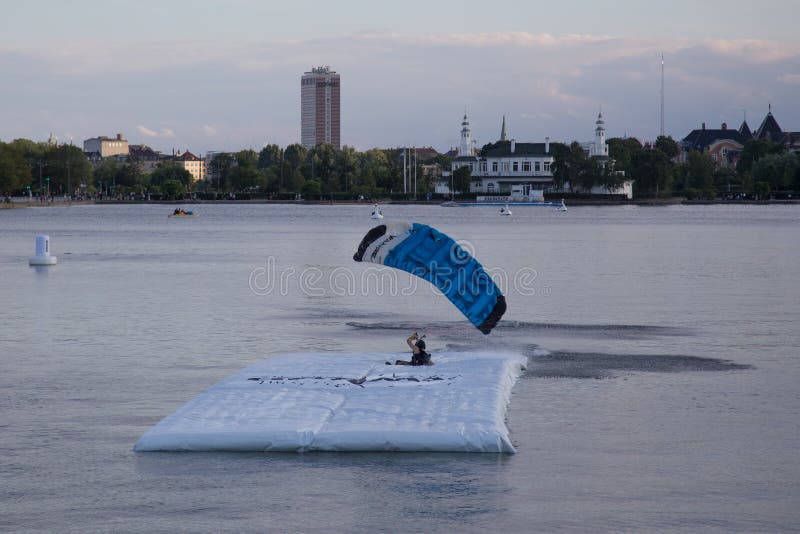 Copenhagen, Denmark - July 30, 2016: A skydiver landing on a pontoon in a lake for the Copenhagen Swoop Challenge. Copenhagen, Denmark - July 30, 2016: A skydiver landing on a pontoon in a lake for the Copenhagen Swoop Challenge.