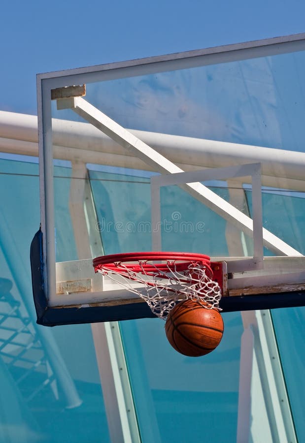 Basketball swooshes through a basketball hoop during a basketball