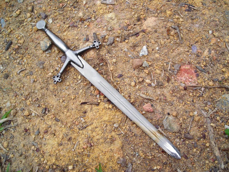 Sword on gravel dirt background