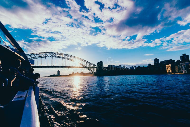 Sydney Harbour Bridge at sunset with sun flare shot from the fer