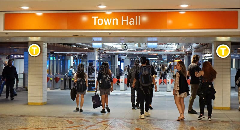 Passengers hurry into Town hall train station underground entrance from the Queen Victoria Building. stock image Passengers hurry into Town hall train station underground entrance from the Queen Victoria Building. stock image