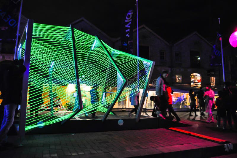 An annual outdoor lighting festival with green tunnel immersive light installations and projections in `Vivid Sydney`.