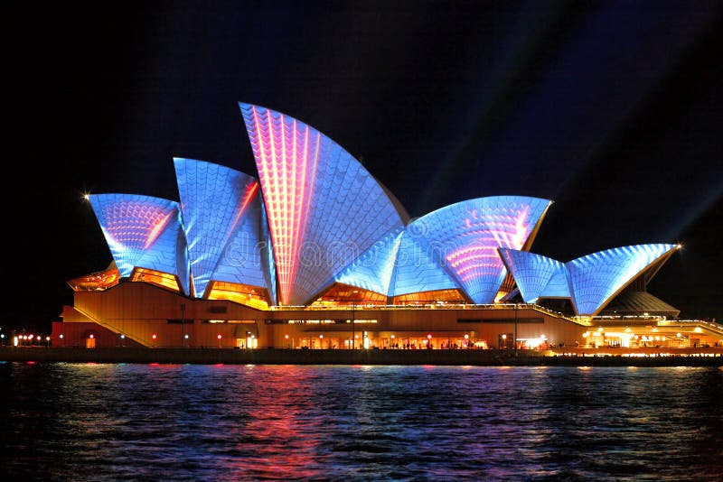 Sydney Opera Hosue illuminated in blue and red motion strips