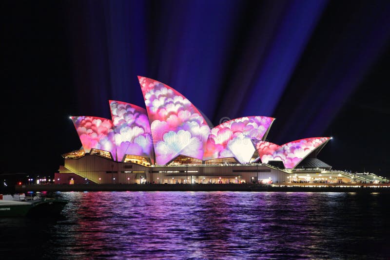 SYDNEY NSW, AUSTRALIA - JUNE 2, 2014; Sydney Opera House sails covered in masses of blue purple and red flowers during Vivid Sydney annual festival event. SYDNEY NSW, AUSTRALIA - JUNE 2, 2014; Sydney Opera House sails covered in masses of blue purple and red flowers during Vivid Sydney annual festival event.