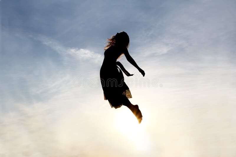 Silhouette of a young woman being raised into the cloudy sky background, as if being sent to Heaven. Silhouette of a young woman being raised into the cloudy sky background, as if being sent to Heaven.