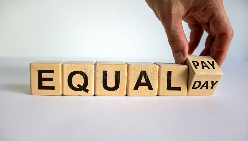 Symbol for the equal pay day. Hand turns a cube and changes the expression `equal pay` to `equal day`. Beautiful white backgro