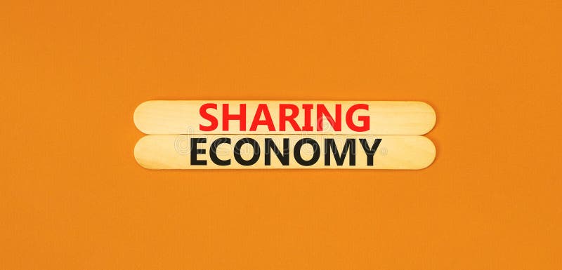 Sharing economy symbol. Concept words Sharing economy on beautiful wooden stick. Beautiful orange table orange background. Business sharing economy concept. Copy space. Sharing economy symbol. Concept words Sharing economy on beautiful wooden stick. Beautiful orange table orange background. Business sharing economy concept. Copy space