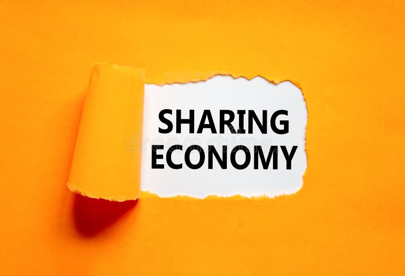 Sharing economy symbol. Concept words Sharing economy on beautiful white paper. Beautiful orange paper background. Business sharing economy concept. Copy space. Sharing economy symbol. Concept words Sharing economy on beautiful white paper. Beautiful orange paper background. Business sharing economy concept. Copy space